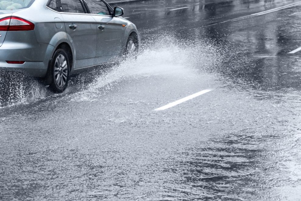 21549007 - car driving on huge puddle during a downpour