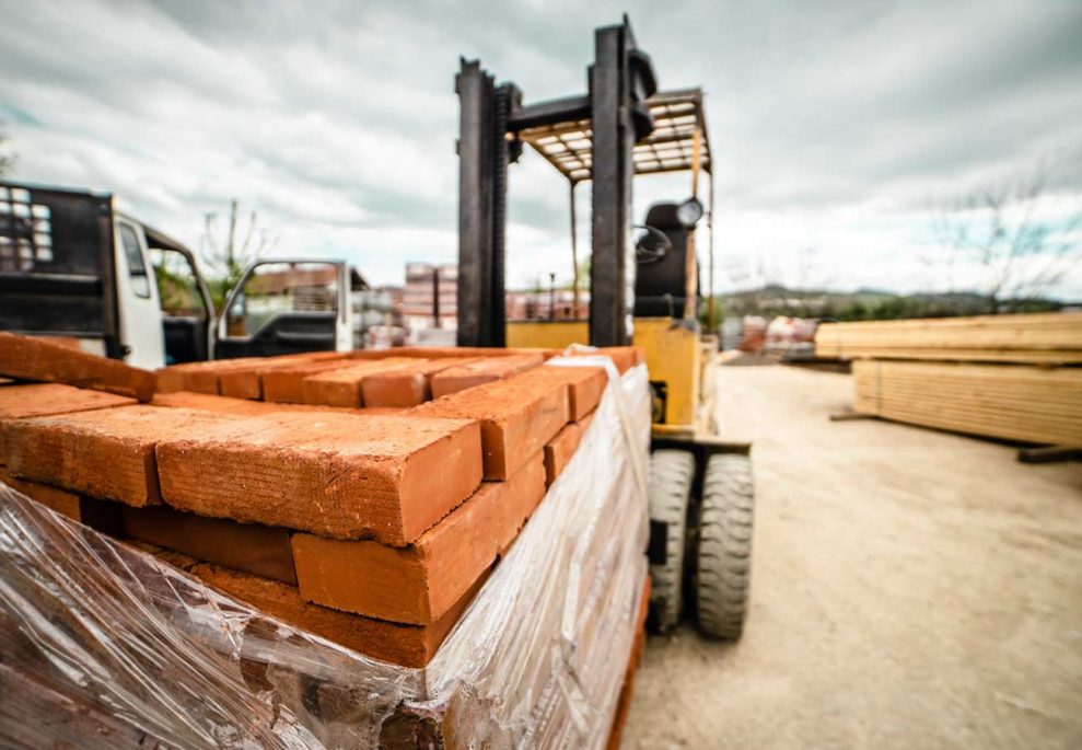 A forklift carries a pallet of bricks on a construction site here in Los Angeles, California.