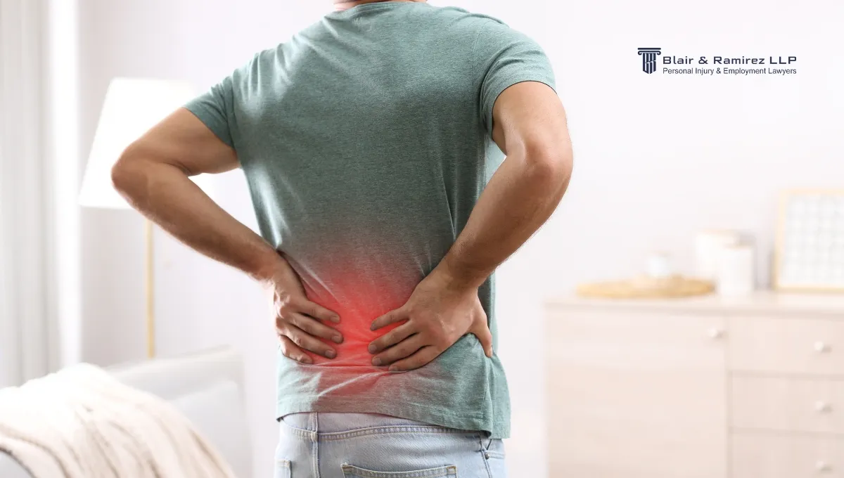Spine injuried person holding his back for relief