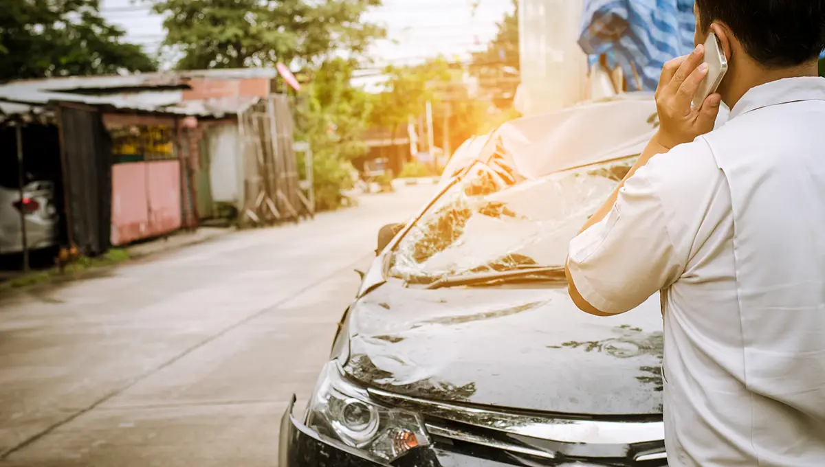 Close-up of accident evidence including photos, reports, and insurance documents