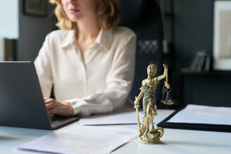 Injured person reviewing documents after a crash, considering hiring a lawyer.