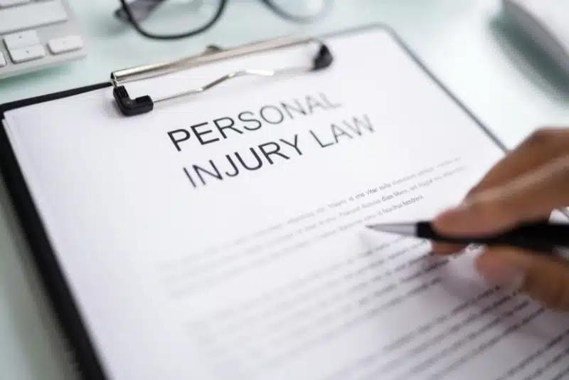 Personal injury law document being reviewed with pen.