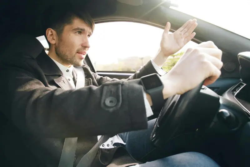 Passenger documenting unsafe Uber driver behavior after troubling rideshare experience in city traffic