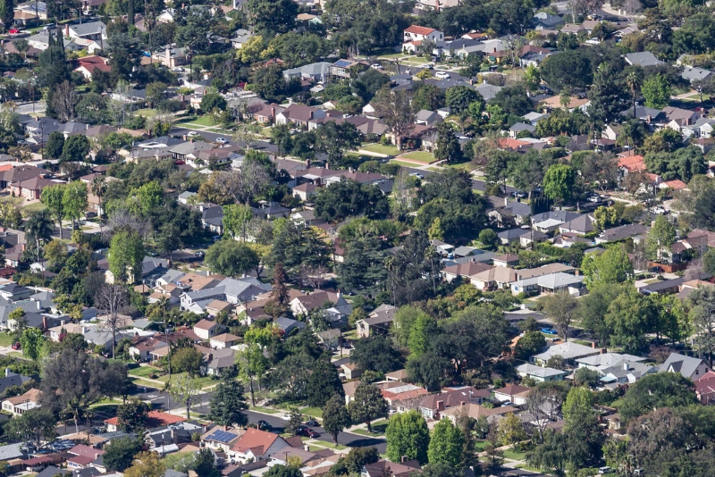 Aerial view of a residential neighborhood in Los Angeles, California, showcasing houses, streets, and greenery.