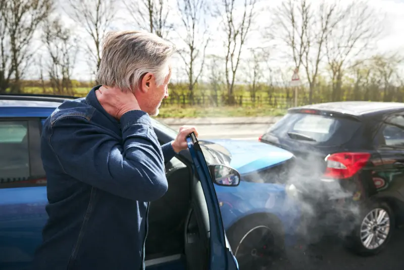 Car accident victim experiencing neck pain and seeking legal guidance